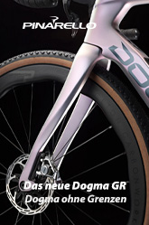 Das neue Dogma GR: Dogma ohne Grenzen. Das Bild zeigt den vorderen Teil eines Gravel-Bikes. Gabel, Bremsscheibe, Teile des Reifens, Teile des Rahmens und Teile des Lenkers sind erkennbar. Es ist das neue Dogma GR.